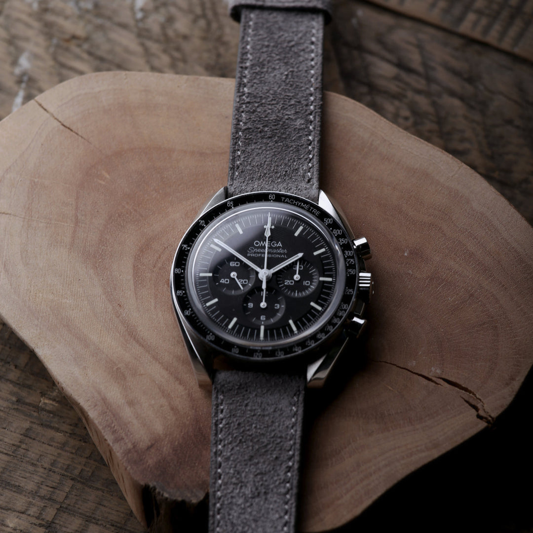 Omega Speedmaster with best handmade leather watch strap in brown on a wooden desk, premium style inspiration